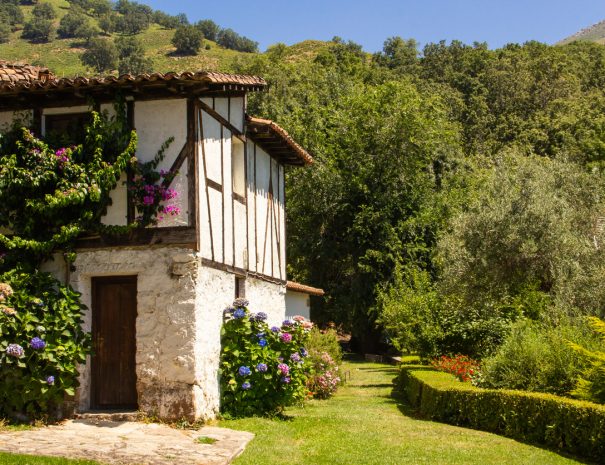 Old and traditional Spanish house among green vegetation.