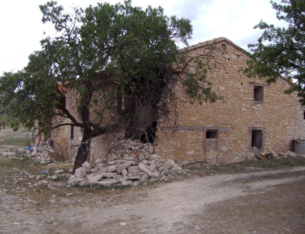 Dilapidated house in an abandoned village. Stone house in an abandoned village in Spain in the middle of trees and a lot stones