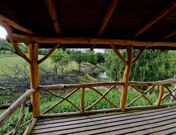 the observation terrace is a haven for game watchers in the reserve. a cozy pergola made of roughly processed beams from acacia branches. the railing is netted around the fence, polygon