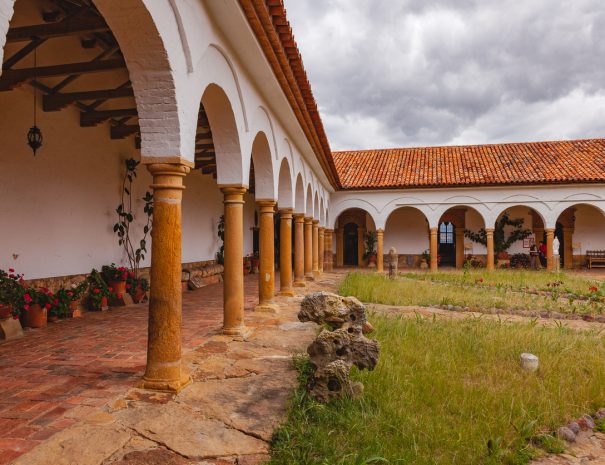 Villa de Leyva, Colombia - September 14, 2014: The Monastery of Santo Ecce Homo which was founded In 1620. In 1998 the buildings, including the connected church, were declared as national architectural heritage in Colombia. Some visitors are seen to the far right. Photo shot in the midday sunlight on an overcast day; horizontal format. Copy space. Camera: Canon EOS 5D MII. Lens: Canon EF 24-70mm F2.8L USM.