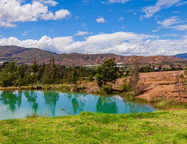 Villa de Leyva, Colombia - Pools of water near the Andes town of Villa de Leyva, known locally as Pozos Azules, or translated into English, Blue Pools. The area is semi arid and like a desert in certain places. Even though the elevation today is over 7000 feet above mean sea level, millions of years ago all of this area was under the sea: it is therefore not difficult to imagine why the land today is a semi desert. The plastic tented areas in the background are where vegetables are being grown. The plastic sheets shield the vegetables from unnecessary climatic conditions. Photo shot in the morning sunlight; horizontal format. Camera: Canon EOS 5D MII. Lens: Canon EF 24-70mm F2.8L USM.