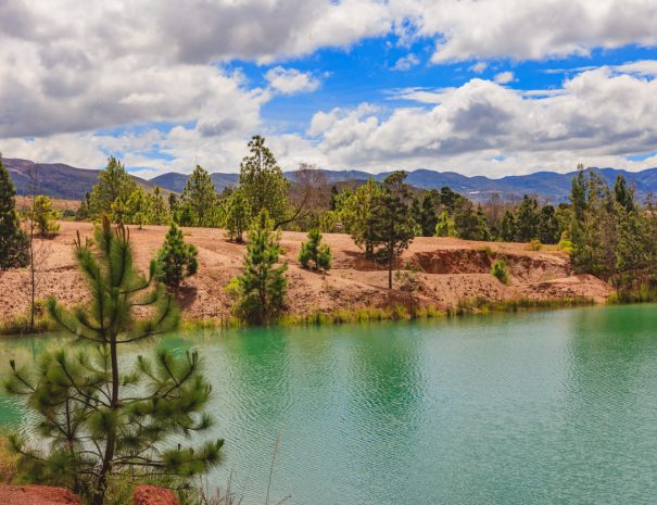 Villa de Leyva, Colombia - Pools of water near the Andes town of Villa de Leyva, known locally as Pozos Azules, or translated into English, Blue Pools. The area is semi arid and like a desert in places. Even though the elevation today is over 7000 feet above mean sea level, millions of years ago all of this area was under the sea: it is therefore not difficult to imagine why the land today is a semi desert. The plastic tented areas in the background are where vegetables are being grown. The plastic sheets shield the vegetables from unnecessary climatic conditions. Photo shot in the morning sunlight; horizontal format. Camera: Canon EOS 5D MII. Lens: Canon EF 24-70mm F2.8L USM.